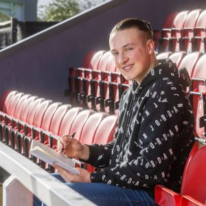 Archie Brown, a former ʼһ Esports student sat in the stands in a football stadium.